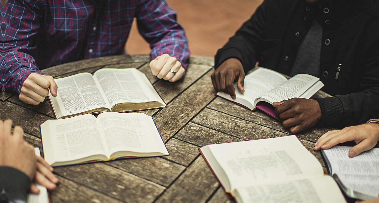 group of people reading bible