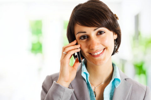 business lady smiling while holding her phone