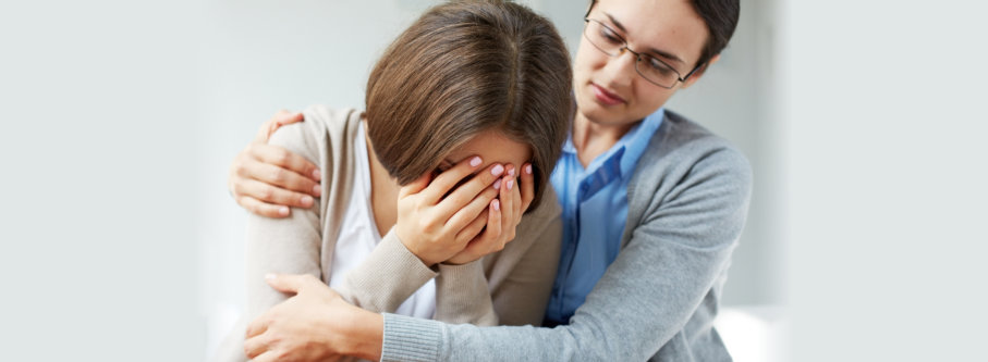 therapist hugging a crying woman